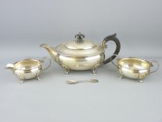 THREE PIECE SILVER TEA SERVICE - each of oval plain form with beadwork rims and on four shell and