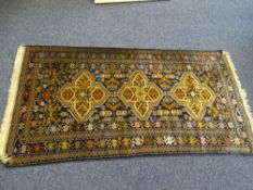 EASTERN STYLE WOOLLEN RUNNER, blue ground with toneall browns central pattern and multi bordered