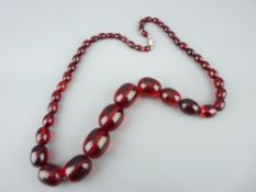 CHERRY AMBER STYLE NECKLACE of graduated beads, 2.5cms the largest