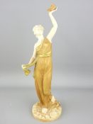 ROYAL WORCESTER - a blush figurine of a standing lady holding aloft a dove of peace, 1914, 27cms