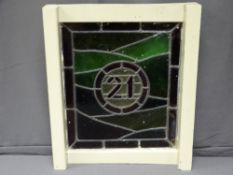 STAINED GLASS LEADED LIGHT PANEL, the circular centre with No 21, 55.5 x 49cms