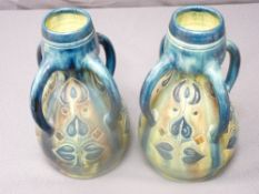 PAIR OF GREEN & BLUE GLAZED QUADRUPLE HANDLED TAPERED VASES with narrow necks, 27cms height