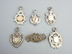 SILVER TROPHY PENDANTS including two with yellow metal, possibly gold mounts, 16.9gms, three further