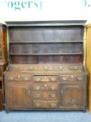 LATE 18TH CENTURY CONWY VALLEY OAK DRESSER, the shaped rack with wide back boards and five lower
