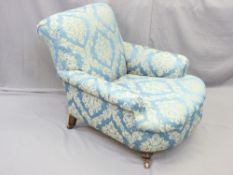 CIRCA 1900 ARMCHAIR in classical style re-upholstery on brass cup and brown pot castors, 80cms H,