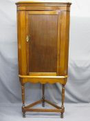 CIRCA 1900 SINGLE DOOR CORNER CUPBOARD ON STAND with turned supports, 178.5cms H, 77cms W