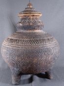 AN EASTERN POTTERY BALUSTER VASE on three feet with lid, 48cms height, 35cms diameter