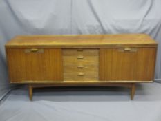 MID-CENTURY TEAK LONG SIDEBOARD of four central drawers and twin drop down flanking cupboard