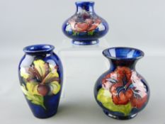 THREE MOORCROFT HIBISCUS MINIATURE VASES, variously shaped, all blue ground, 10cms, 10.5cms and 7.