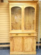 STRIPPED WOOD TWO DOOR BOOK CASE SIDEBOARD with arched top twin glazed doors over a single frieze
