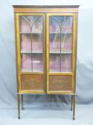EDWARDIAN MAHOGANY TWO DOOR DISPLAY CABINET with inlaid and painted detail on tapering supports