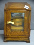 VINTAGE OAK SMOKER'S CABINET with wooden tobacco jar and pipes to the interior, 32cms H