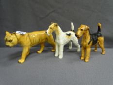 BESWICK MODEL OF A LIONESS, a terrier dog and a similar model by Royal Doulton HN1023, damage to one
