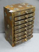 EASTERN/ORIENTAL COLLECTORS CHEST of eight drawers with white metal mounts and decoration, 34cms H