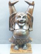 EASTERN CARVED PEDESTAL of a man with arms raised, 56cms H