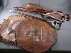 TWO SHOOTING STICKS, a horse whip and another stick, three leather seat covers and a skittle