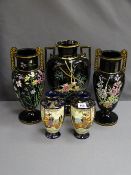 THREE JACKFIELD TYPE BLACK POTTERY VASES with raised enamel paint decoration and a pair of