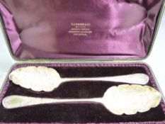 SILVER SERVING SPOONS, a cased pair, well decorated with leaf scrolled bowls and handle top, 4.3ozs,