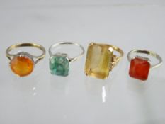 9CT GOLD DRESS RING with large oblong citrine and three other white metal dress rings, total 20.