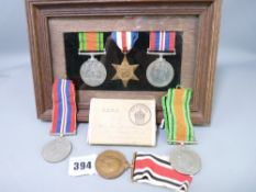 WWII MEDALS unnamed, including a group of three within an oak frame and a Victory and Defence pair