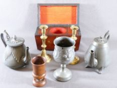 SARCOPHAGUS SHAPED TEA CADDY, treen beaker, three pieces of pewter and a pair of brass candlesticks