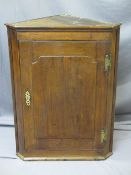ANTIQUE OAK WALL HANGING CORNER CUPBOARD with brass H hinges and escutcheon, 89.5cms H, 68cms W