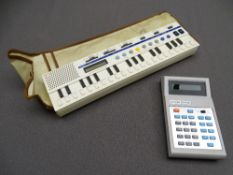 CASIO VL - TONE PORTABLE KEYBOARD with case and a similar era calculator by Citizen