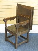 A MONK'S BENCH TYPE ARMCHAIR, circa 1800 with canted decoration to the supports, 73.5cms H, 64cms W,