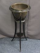 EBONIZED JARDINIERE STAND with brass liner and chain with lion mask detail, 62cms H, 37.5cms