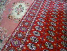 MODERN IRANIAN SILK CARPET - red ground with repeating central pattern and triple bordered edge, 275