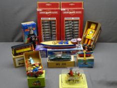 VINTAGE TYPE CLOCKWORK TIN PLATE TOYS (8) along with a Schylling's wooden motor speed boat with
