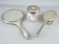 THREE ITEMS OF SILVER DRESSING TABLE WARE to include a circular hand mirror, brush and lidded cut
