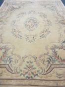LARGE WASHED WOOLLEN CARPET - all-over floral pattern on a central cream ground with pink borders