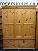 VICTORIAN PINE STYLE TRIPLE WARDROBE with two upper doors and central panel and a base arrangement
