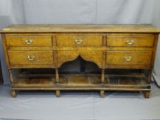 18TH CENTURY SHROPSHIRE DRESSER BASE with arrangement of five drawers, central shaped apron and