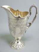 SILVER CREAM JUG, finely shaped, classical bright cut style with scrolled handle and circular