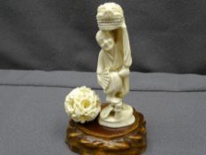 JAPANESE CARVED IVORY OKIMONO OF A STANDING FIGURE holding a lion mask aloft, 14cms H, a canton type