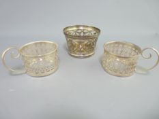 THREE SILVER HOLDERS, all pierced including a 4.5cms H bowl/dish holder, 7cms diameter, London
