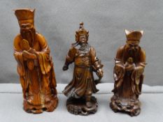 THREE CARVED WOODEN FIGURINES OF CHINESE DEITIES, 24cms H the tallest