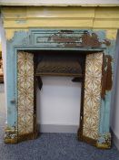 VICTORIAN CAST IRON FIRE SURROUND with mantel shelf and inset colourful tiles, 114cms H, 111cms