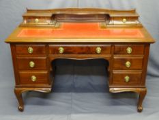 FRENCH STYLE MAHOGANY KNEEHOLE DESK with tooled red leather top, two upper drawers and interesting