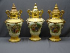STAFFORDSHIRE VASES - a trio of twin-handled elaborately decorated with lids, approximately 50cms H