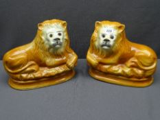STAFFORDSHIRE RECUMBENT LIONS, a pair