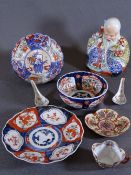 JAPANESE IMARI WARE to include a seated figurine, two bowls, a 22cm plate, fine porcelain cup and