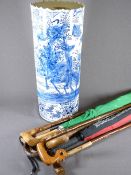 BLUE & WHITE POTTERY STICK STAND with quantity of canes and umbrellas, 54cms H