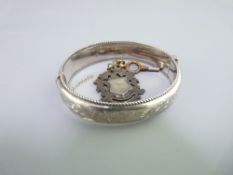 CHASED DECORATED SILVER BANGLE and an Albert watch fob, Chester 1959, 27.2grms and Birmingham