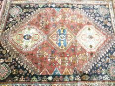 IRAN 100% WOOL PILE RUG - red and blue ground, traditional woven pattern in a central block with