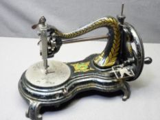 VINTAGE JONES HAND CRANK SEWING MACHINE on a shaped base with decorative gilt detail