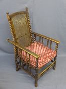 VINTAGE RECLINING ELBOW CHAIR with cane seat and back, bobbin and twist detail