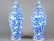 PRUNUS BLOSSOM DECORATED CHINESE VASES, a pair, with temple dog lids, 31cms overall H (AF)
